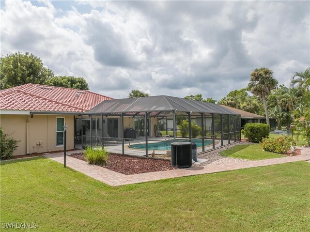 view of property's community with a pool and a lawn