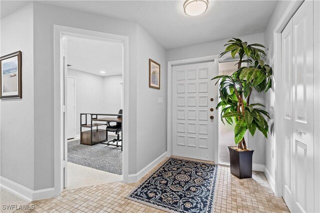 view of carpeted foyer