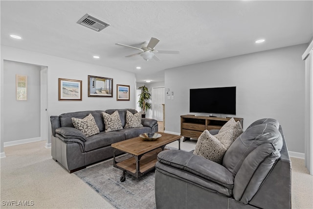 living room with ceiling fan and light carpet