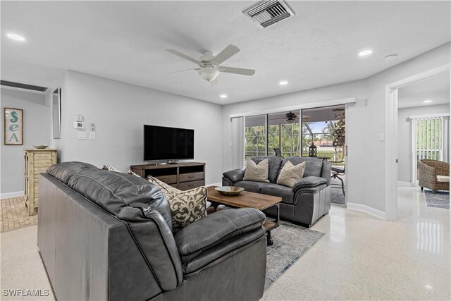 living room with ceiling fan and a healthy amount of sunlight