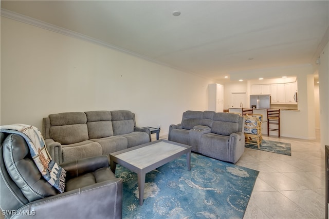 living room with ornamental molding and light tile patterned floors