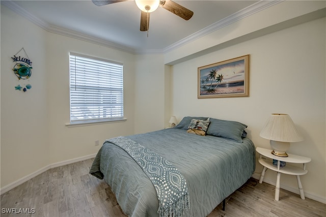 bedroom featuring ornamental molding, light wood-type flooring, and ceiling fan