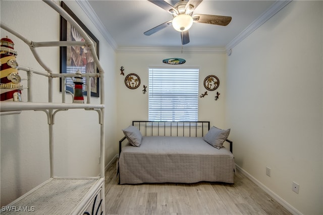 bedroom with light hardwood / wood-style flooring, ornamental molding, and ceiling fan