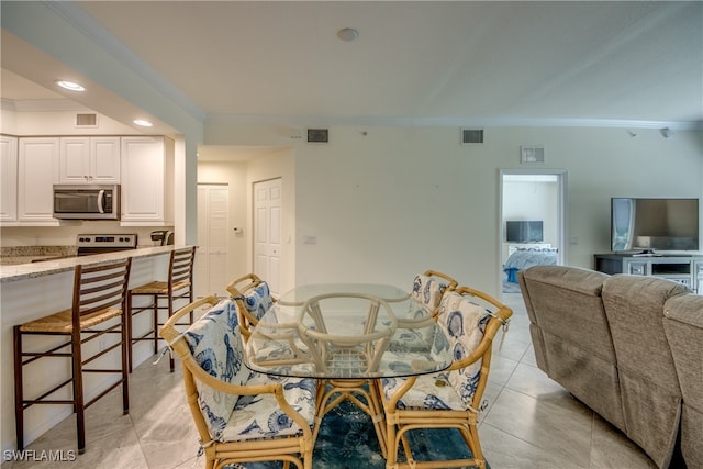 tiled dining space with ornamental molding