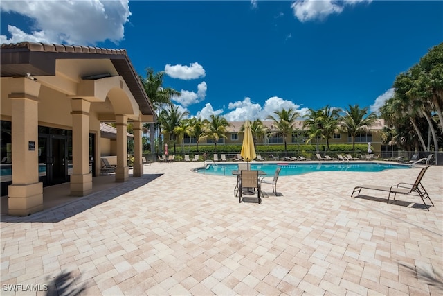 view of swimming pool featuring a patio area