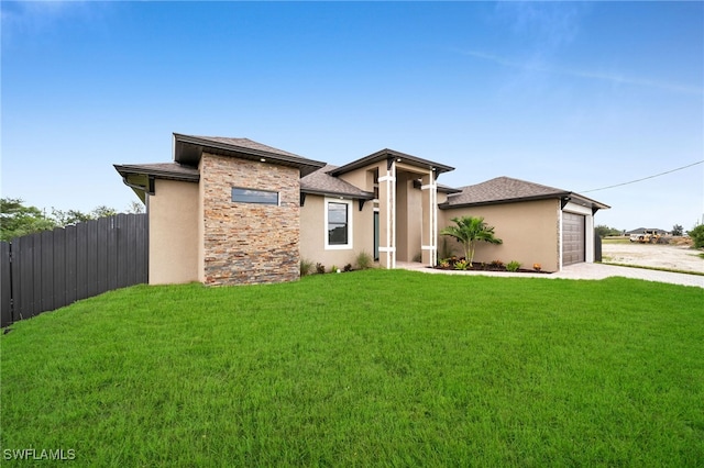 prairie-style house with a front yard and a garage