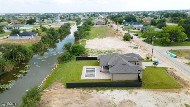 bird's eye view with a water view and a residential view