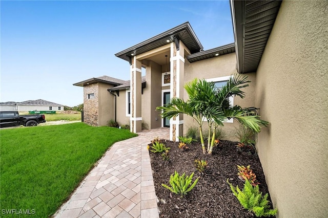 exterior space with a lawn and stucco siding