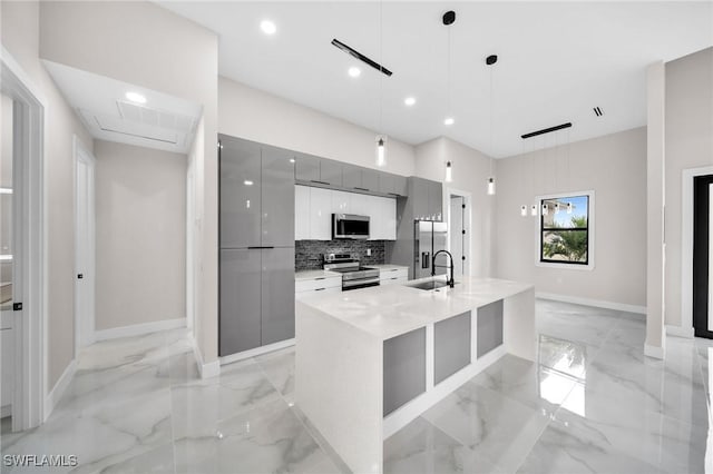 kitchen with pendant lighting, marble finish floor, gray cabinetry, appliances with stainless steel finishes, and modern cabinets