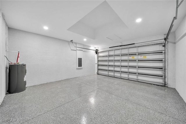 garage featuring recessed lighting, electric water heater, and electric panel