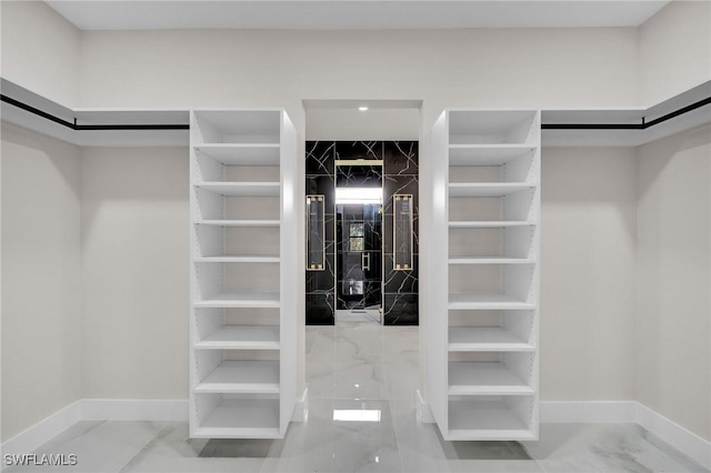 spacious closet with marble finish floor