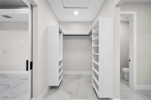 spacious closet with marble finish floor and visible vents