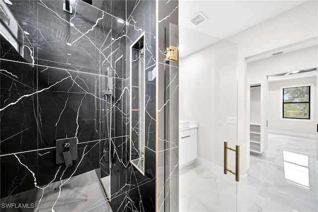 bathroom with a shower with door, tile patterned floors, and vanity