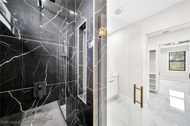 bathroom with marble finish floor, vanity, a marble finish shower, and visible vents