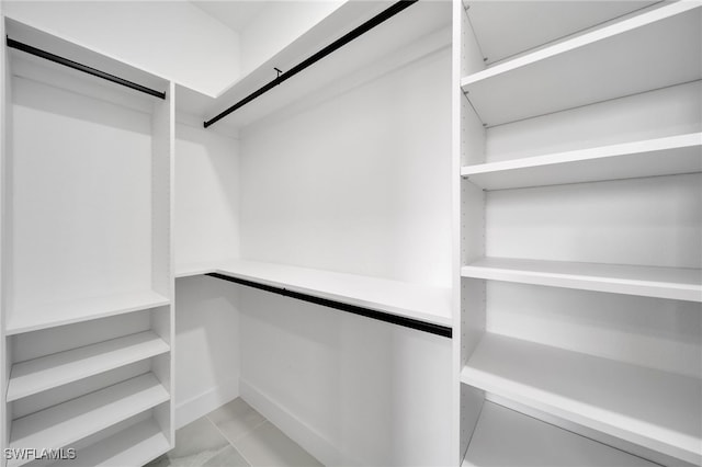 spacious closet featuring light tile patterned floors