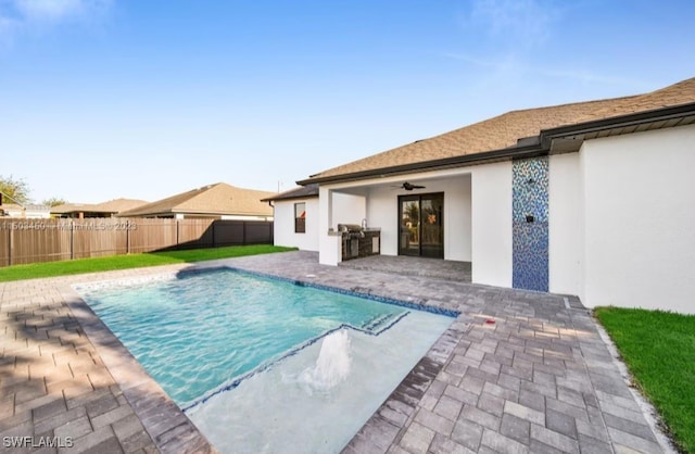 view of swimming pool with a lawn, a patio, and ceiling fan