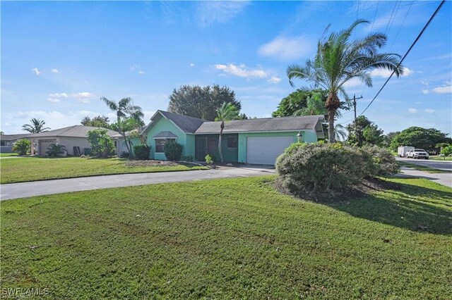 view of front of home featuring a front yard and a garage