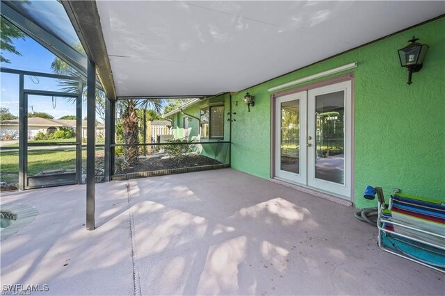 unfurnished sunroom featuring french doors and lofted ceiling