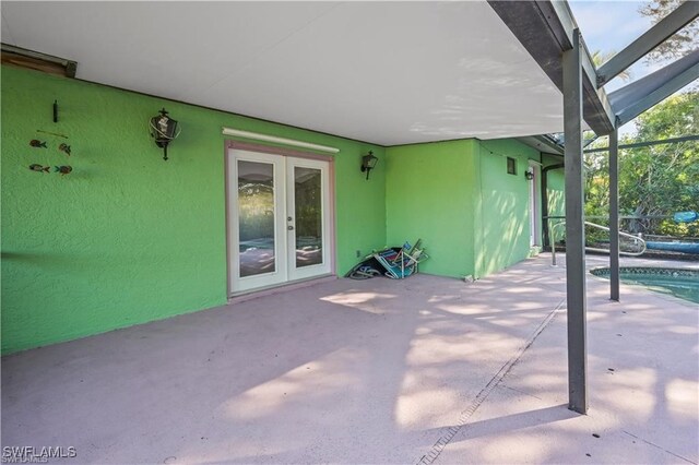 view of patio with a lanai and french doors