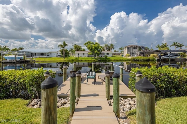 dock area with a residential view and a water view