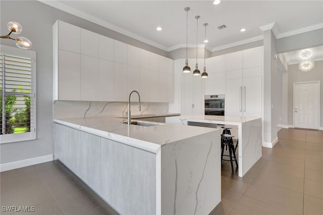 kitchen with sink, white cabinets, light tile patterned floors, and light stone countertops