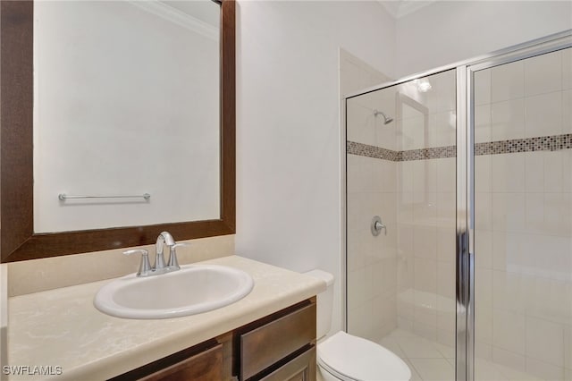 bathroom featuring crown molding, a shower with shower door, vanity, and toilet