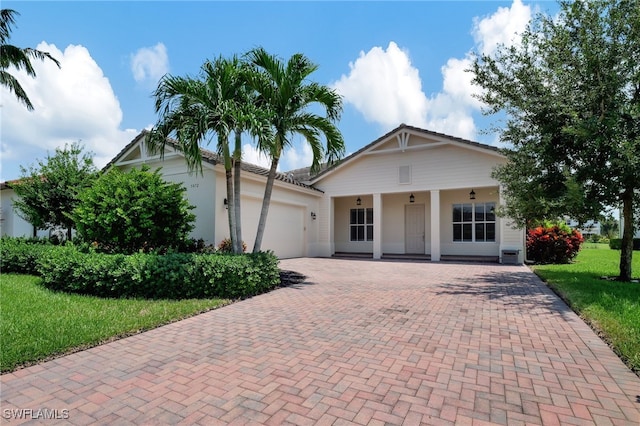 view of front of property featuring a garage and a front lawn