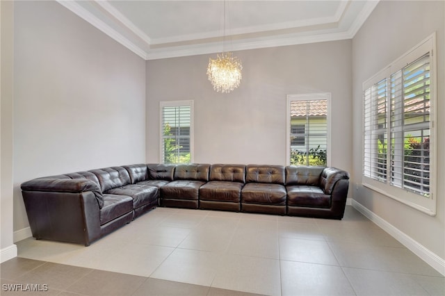 living room featuring a tray ceiling, crown molding, light tile patterned flooring, and an inviting chandelier