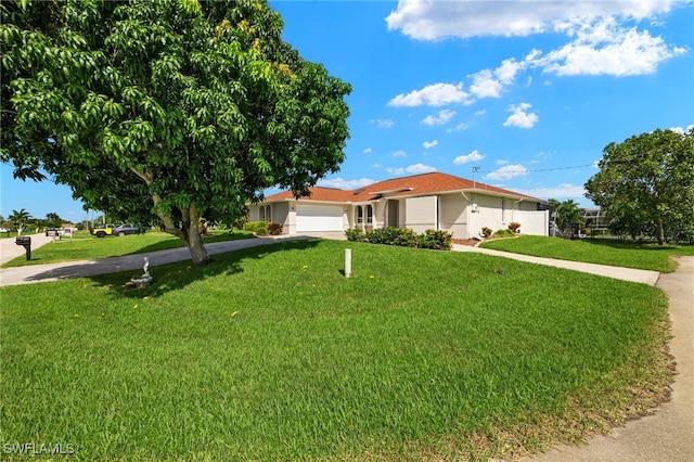 ranch-style house featuring a front yard and a garage