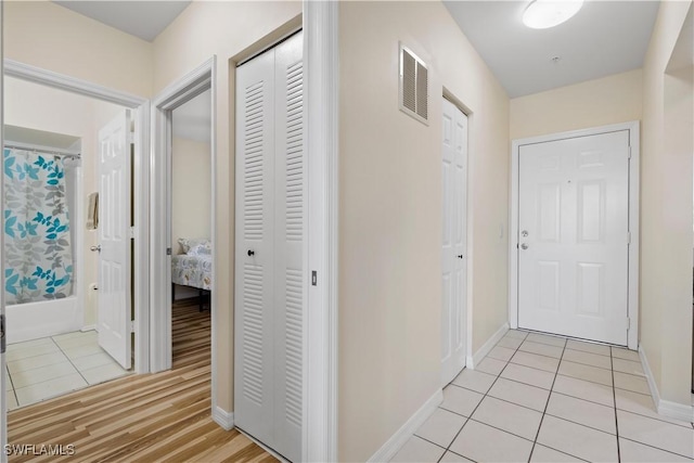 14831 Park Lake Dr Unit 309, Fort Myers, FL 33919 - hallway featuring visible vents, baseboards, and light tile patterned floors