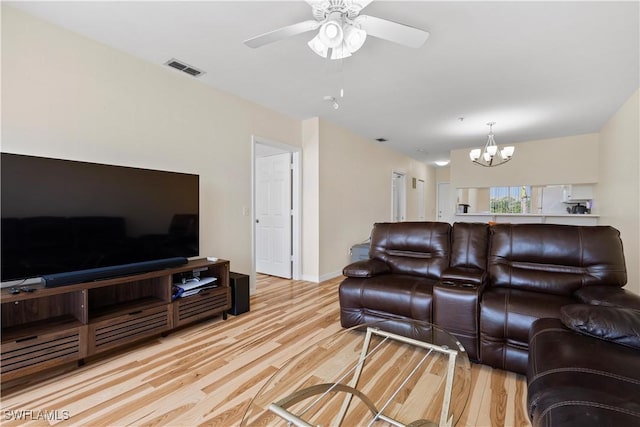 14831 Park Lake Dr Unit 309, Fort Myers, FL 33919 - living area with visible vents, baseboards, light wood finished floors, and ceiling fan with notable chandelier