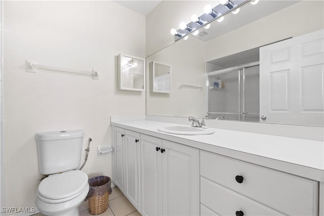 14831 Park Lake Dr Unit 309, Fort Myers, FL 33919 - bathroom with a shower stall, tile patterned floors, vanity, and toilet