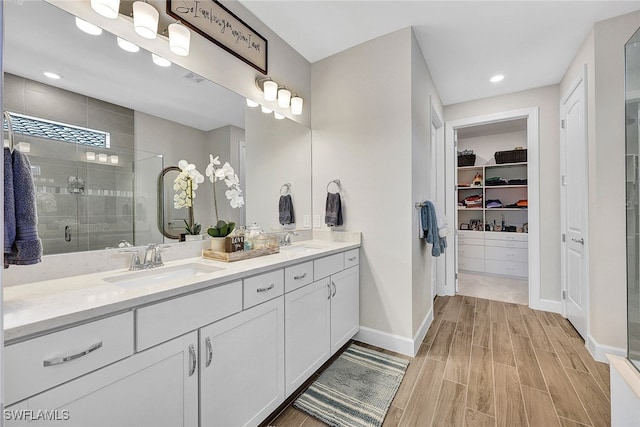 bathroom with vanity and a shower with shower door