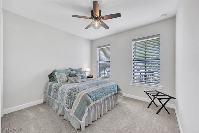 carpeted bedroom with baseboards and ceiling fan