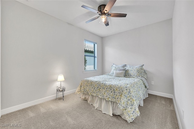 carpeted bedroom featuring baseboards and ceiling fan