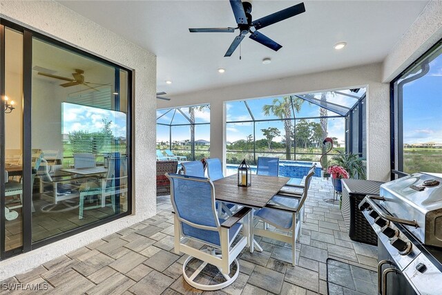 sunroom featuring ceiling fan