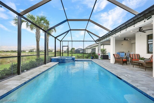 view of pool with a lanai, an in ground hot tub, ceiling fan, an outdoor hangout area, and a patio