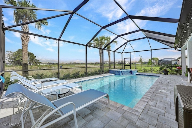 view of swimming pool with an in ground hot tub, a lanai, and a patio