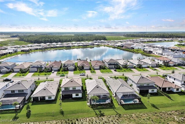 drone / aerial view featuring a residential view and a water view