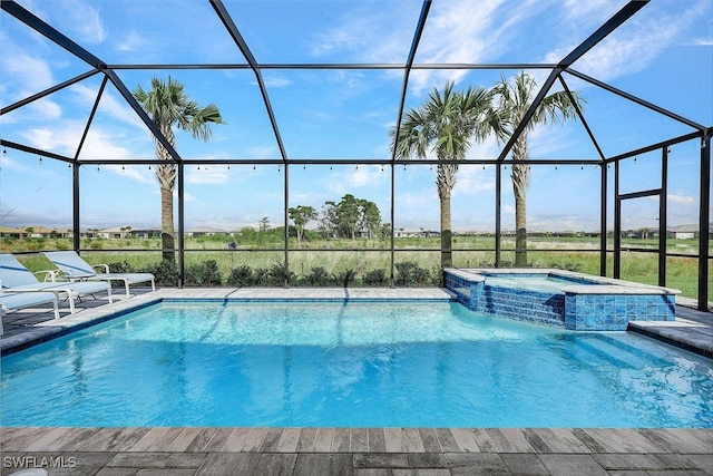 view of pool with an in ground hot tub, glass enclosure, and a patio