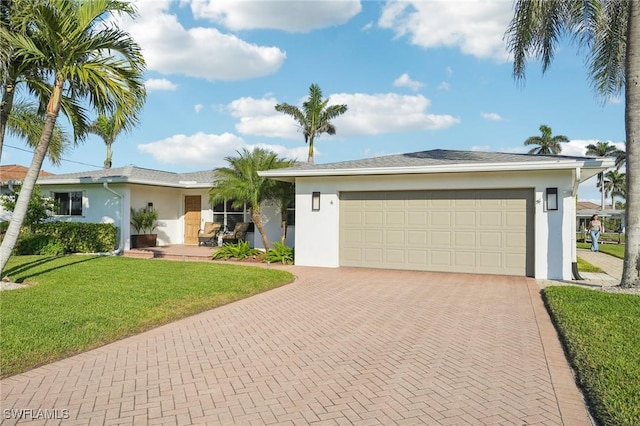 single story home featuring a garage and a front lawn