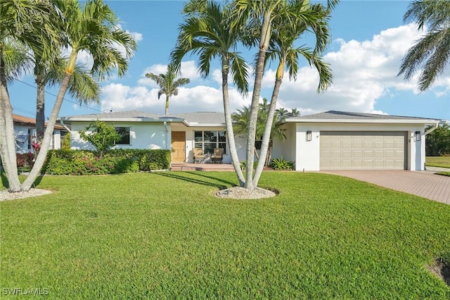 single story home with a garage and a front lawn