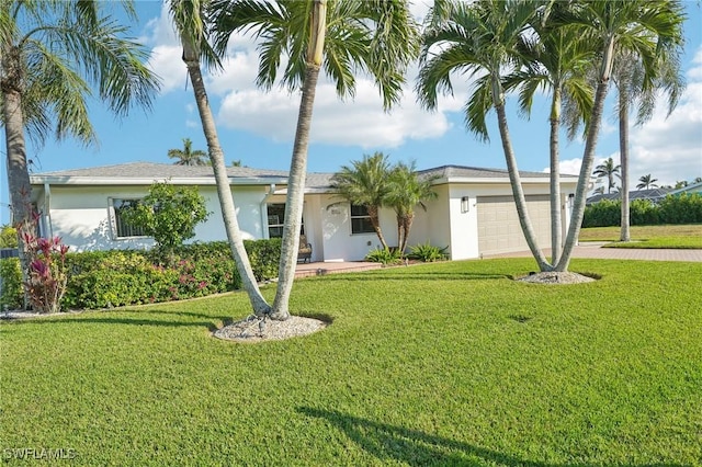 single story home featuring a garage and a front yard