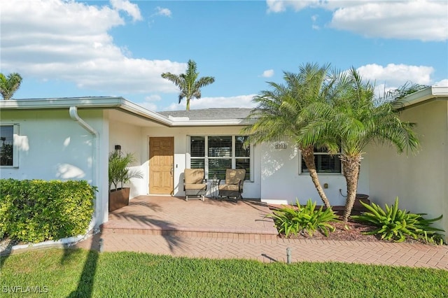 entrance to property featuring a patio