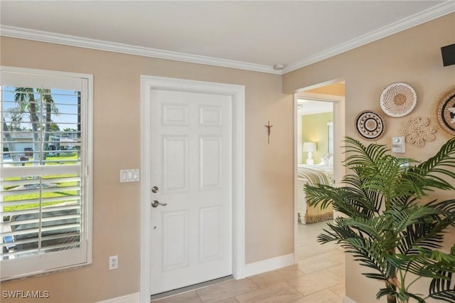 tiled entryway featuring crown molding