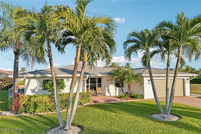 view of front of property featuring a garage and a front lawn