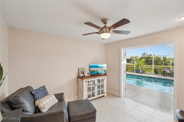 living area featuring light tile patterned floors and ceiling fan