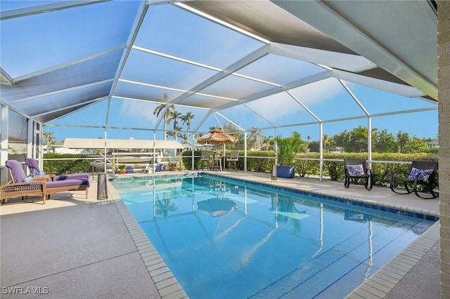 view of pool with a lanai and a patio