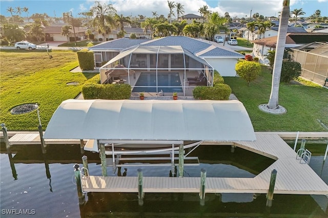 dock area featuring a lanai, a lawn, and a water view