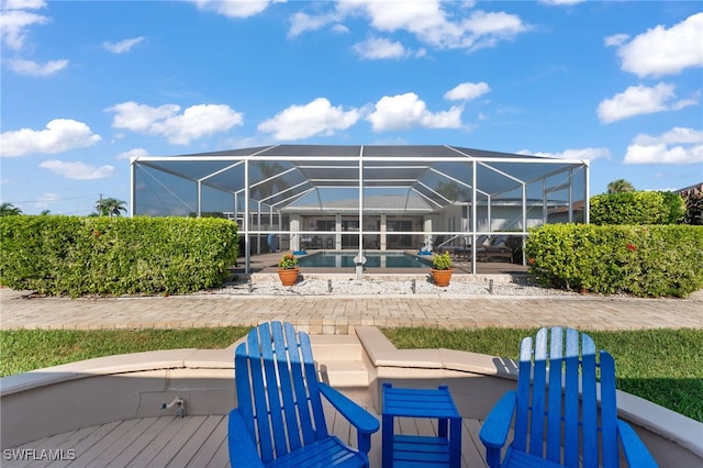 back of house with a patio and glass enclosure